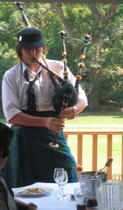 Playing the bagpipes at an IAG Christmas party